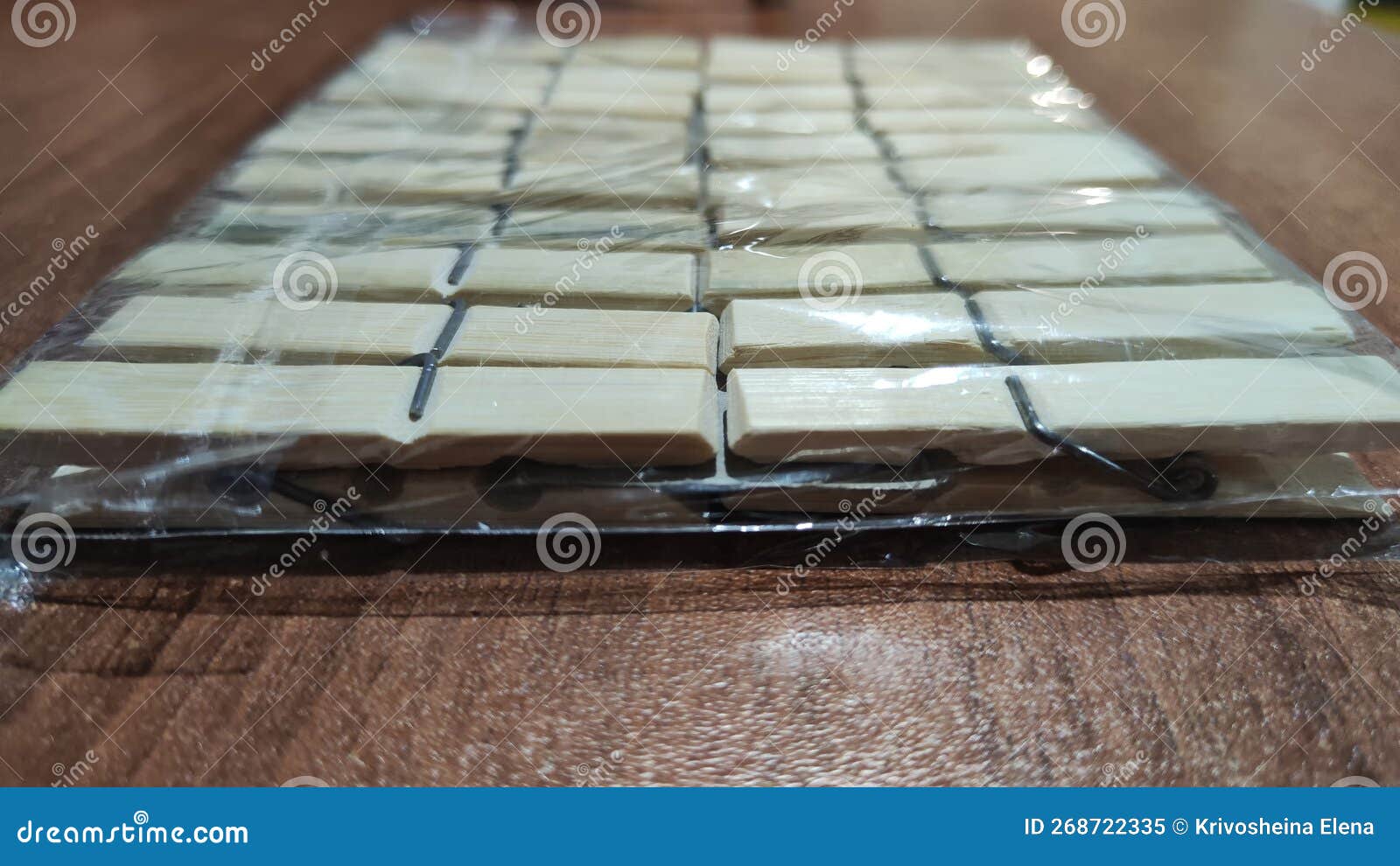 package of wooden white clothespins on a brown wooden surface