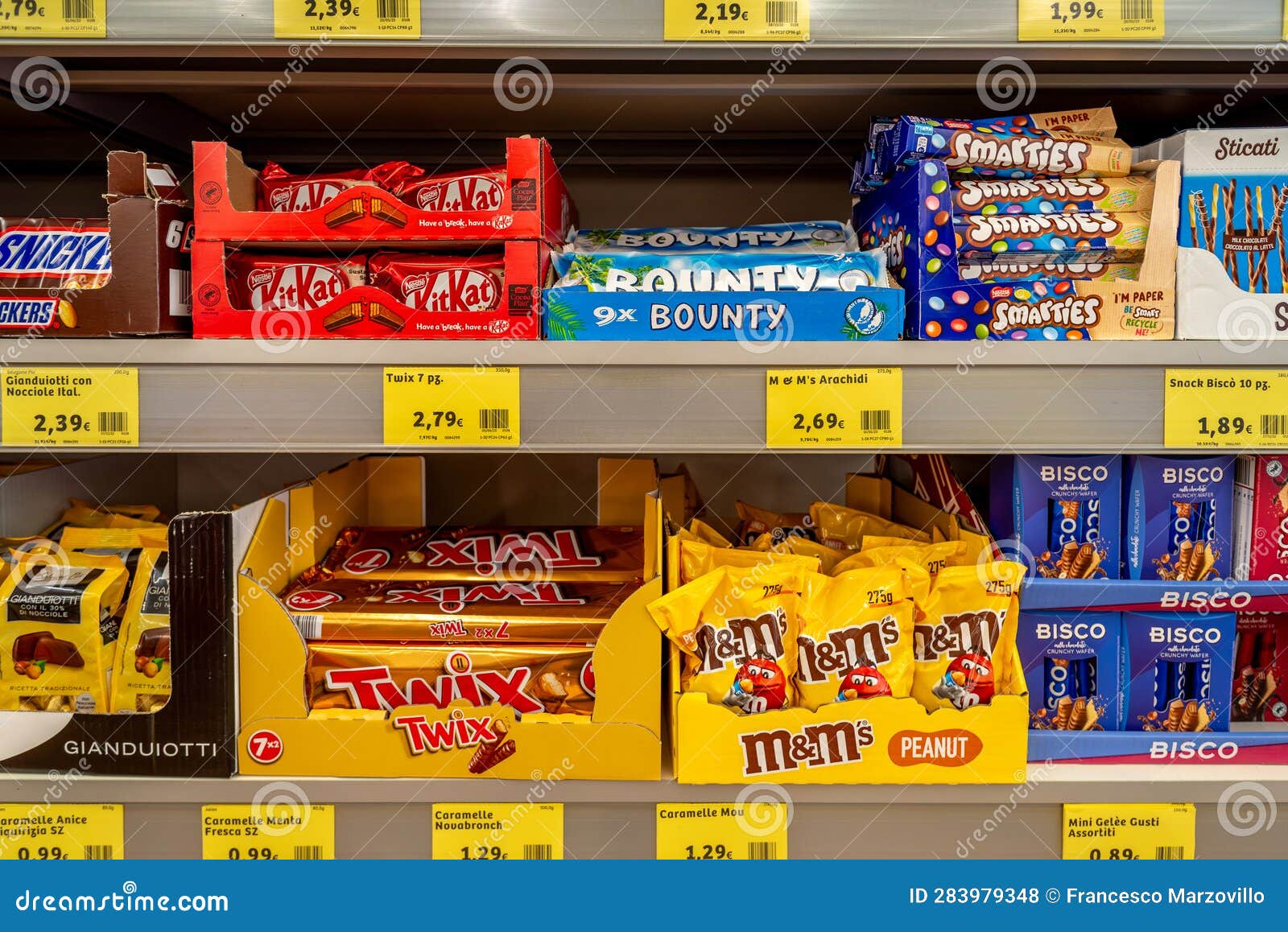 Packages of KitKat and Bounty Candy, Smarties and M and Ms Peanut Candy