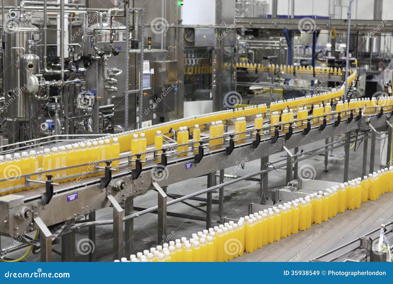 packed bottles moving on conveyor belt in bottling industry