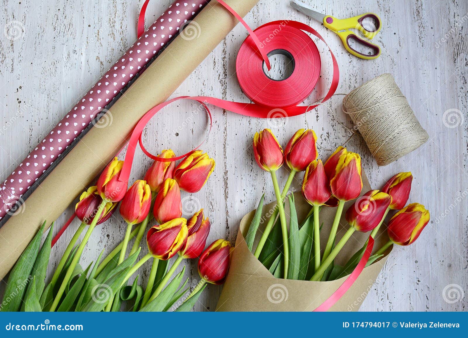 Packing a Bouquet of Red and Yellow Tulips in Craft Paper, Wrapping Paper  Rolls, Scissors and Red Ribbons on a Light Wooden Stock Image - Image of  decorative, closeup: 174794017