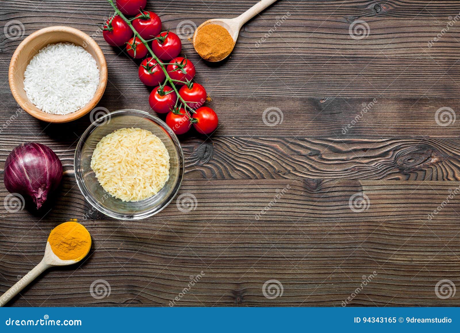 Download Paella Ingredients With Rice, Salt, Spices And Tomatoes On Wooden Table Background Top View ...