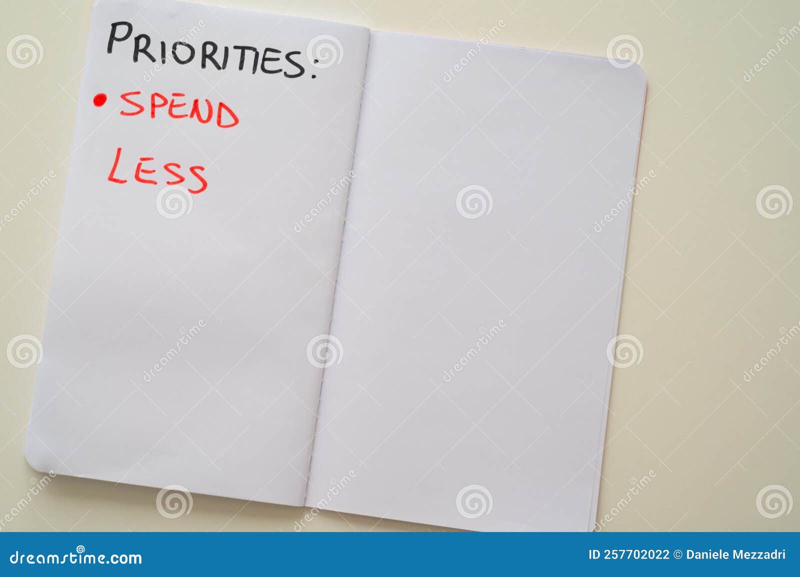 notebook page, with text `priorities: spend less`