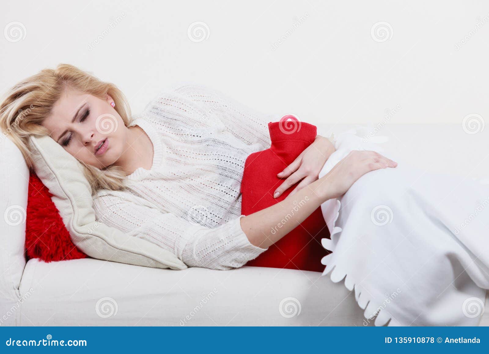 Woman Feeling Stomach Cramps Lying On Cofa Stock Photo - Image of