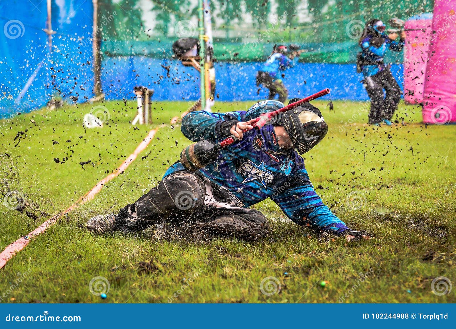 Paint Ball Player Run To Water from Start Editorial Stock Photo