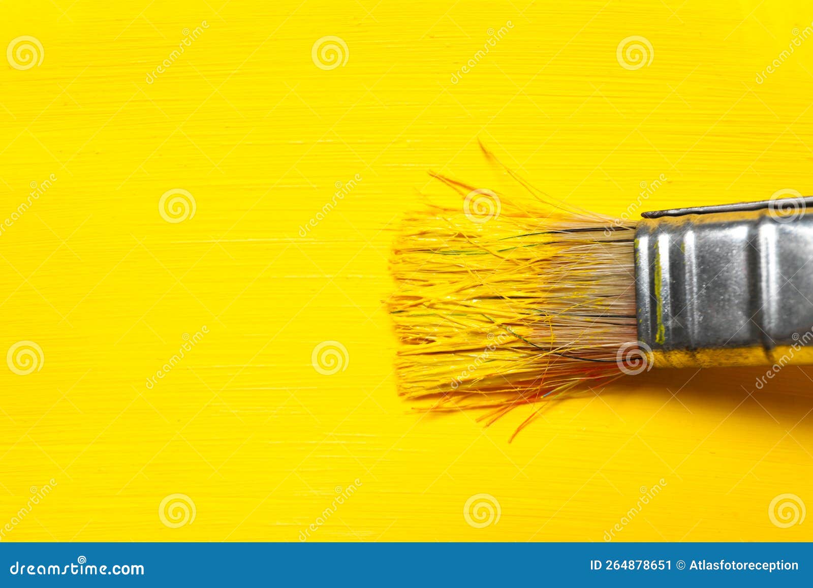 Paint Brush with Yellow Paint and Yellow Paint Background Stock Image