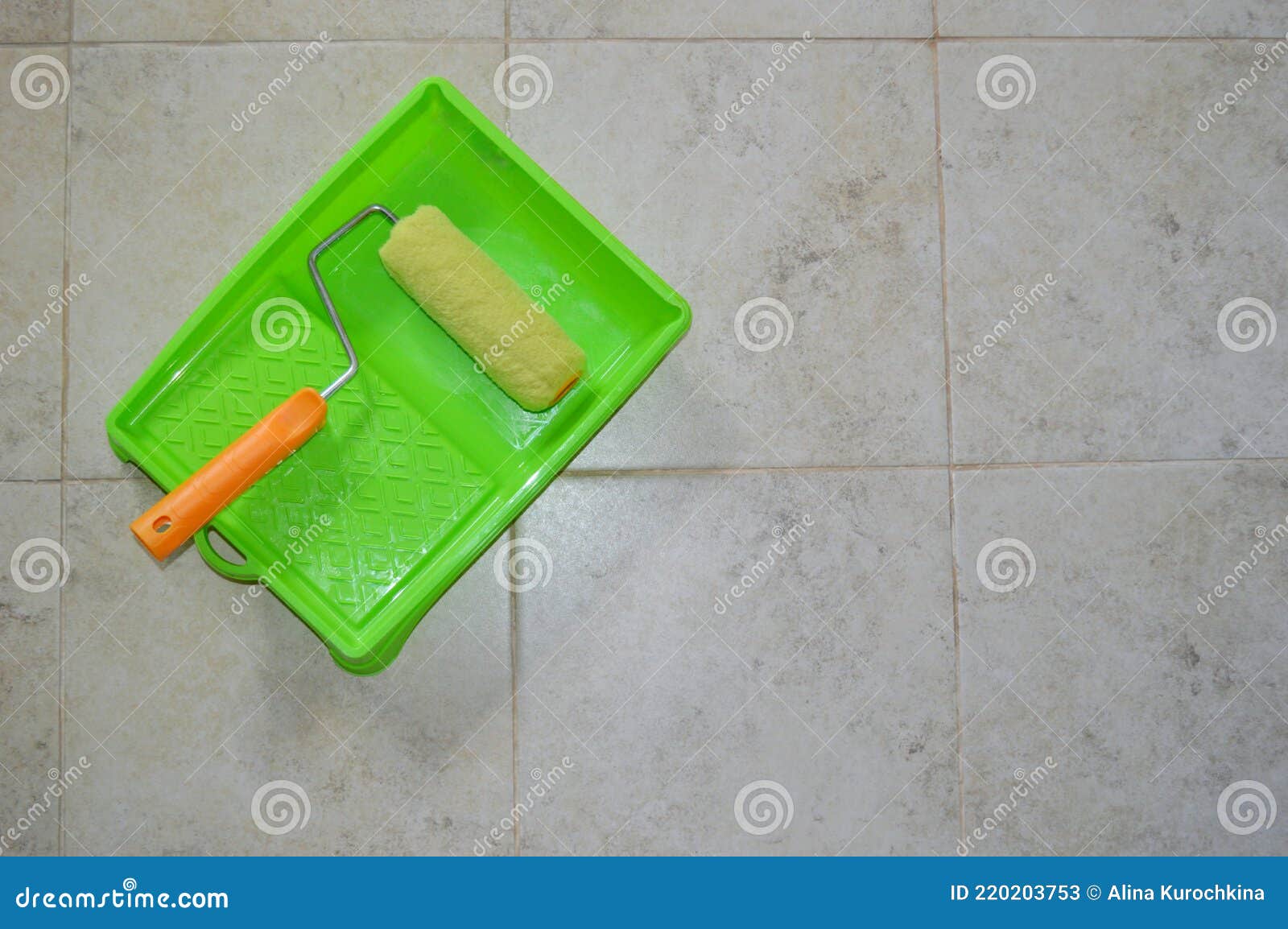 Paint Roller in Green Plastic Tray on Ceramic Tile Background Stock