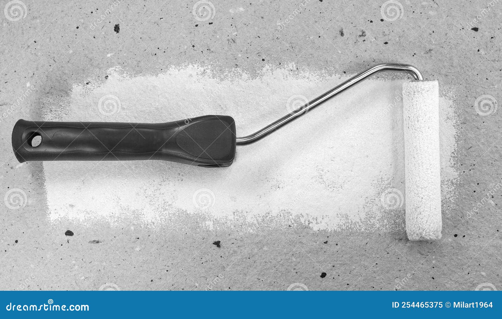 Paint Roller Leaving Stroke of White Color Over a Cardboard Stock Image