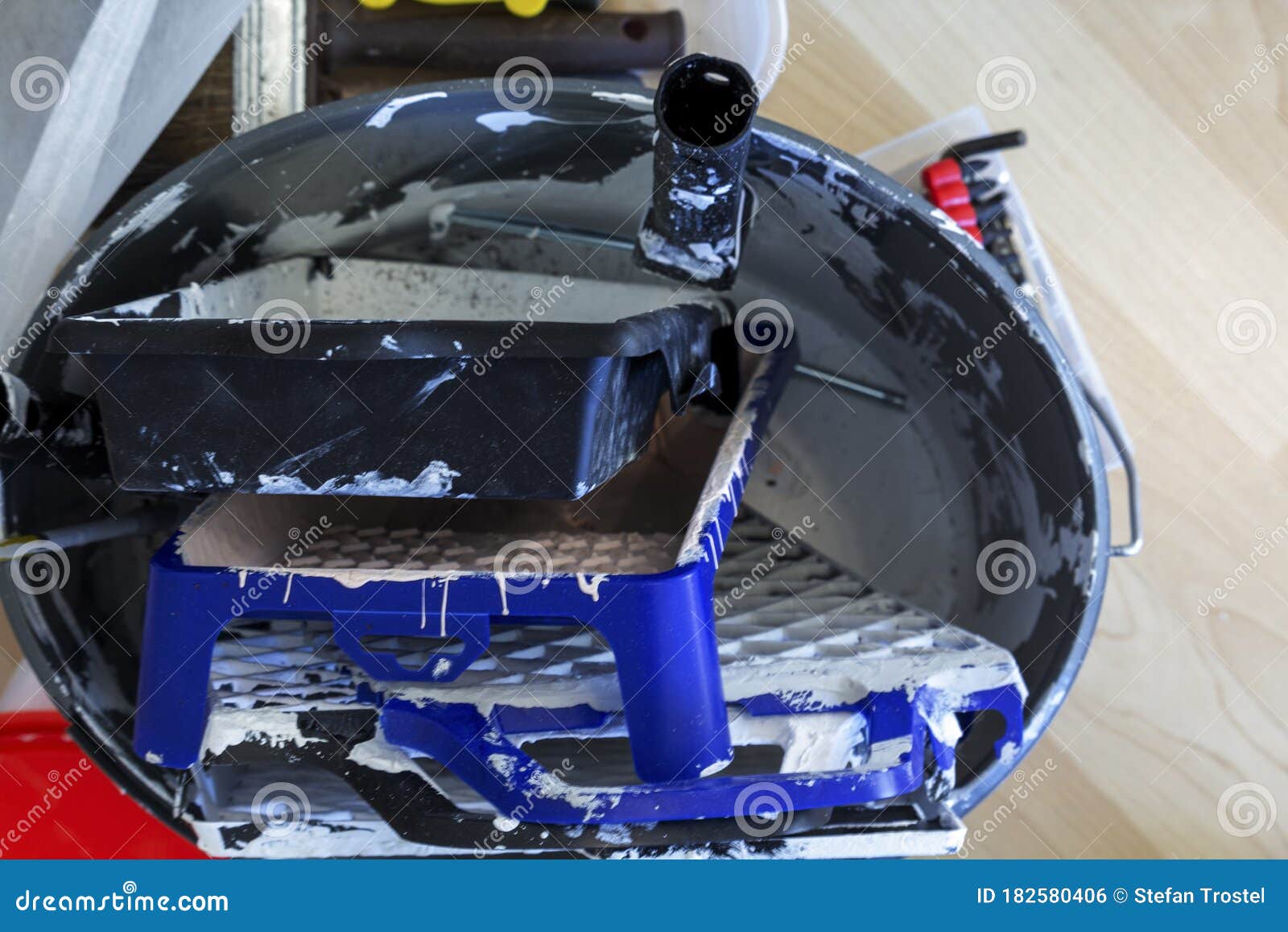 Paint Trays and Scraper Grids Collected in One Bucket Stock Photo