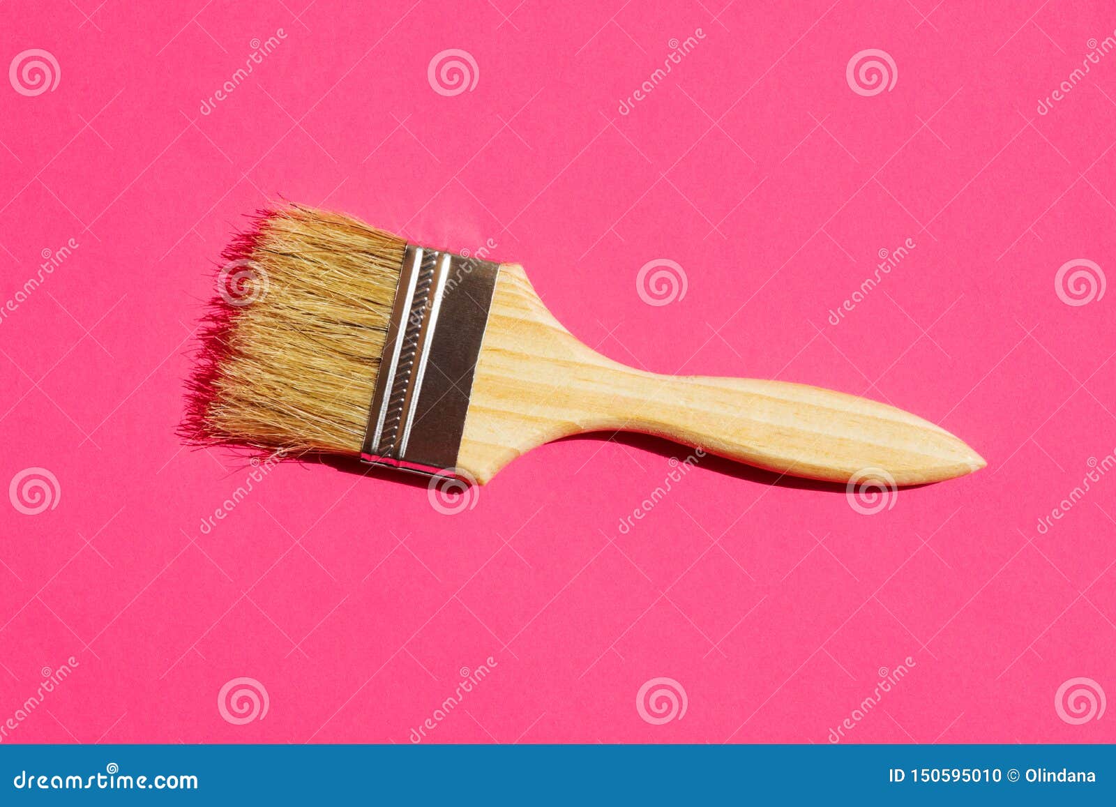 paint varnishing brush with wooden handle varnish on trendy fuchsia pink background. interior  home refurbishing fashion