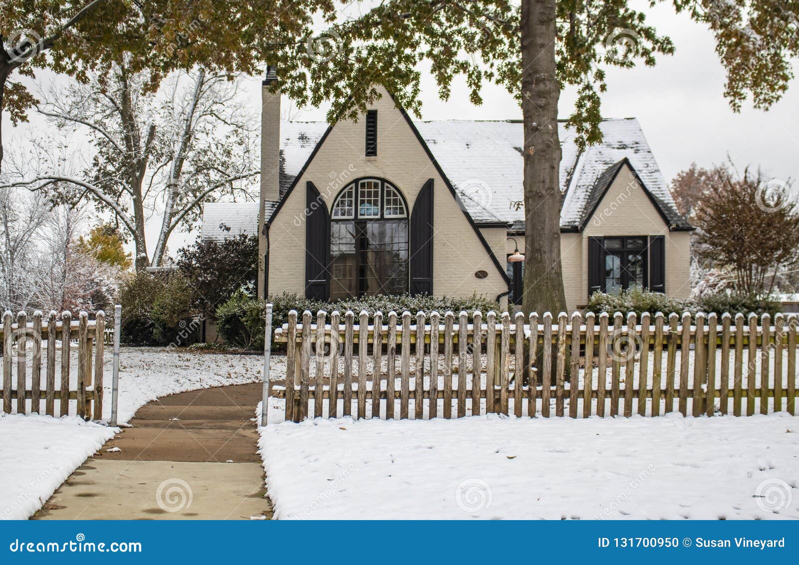 Painted Brick Cottage With Dramatic Front Window And Shutters