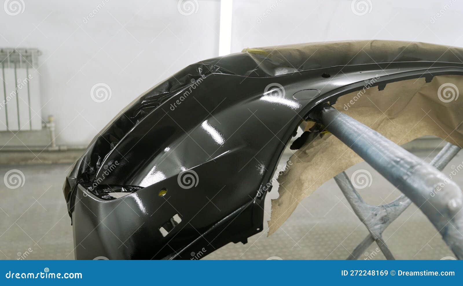 Painted Car Bumper in Garage. Black Bumper Freshly Painted. Stock Image