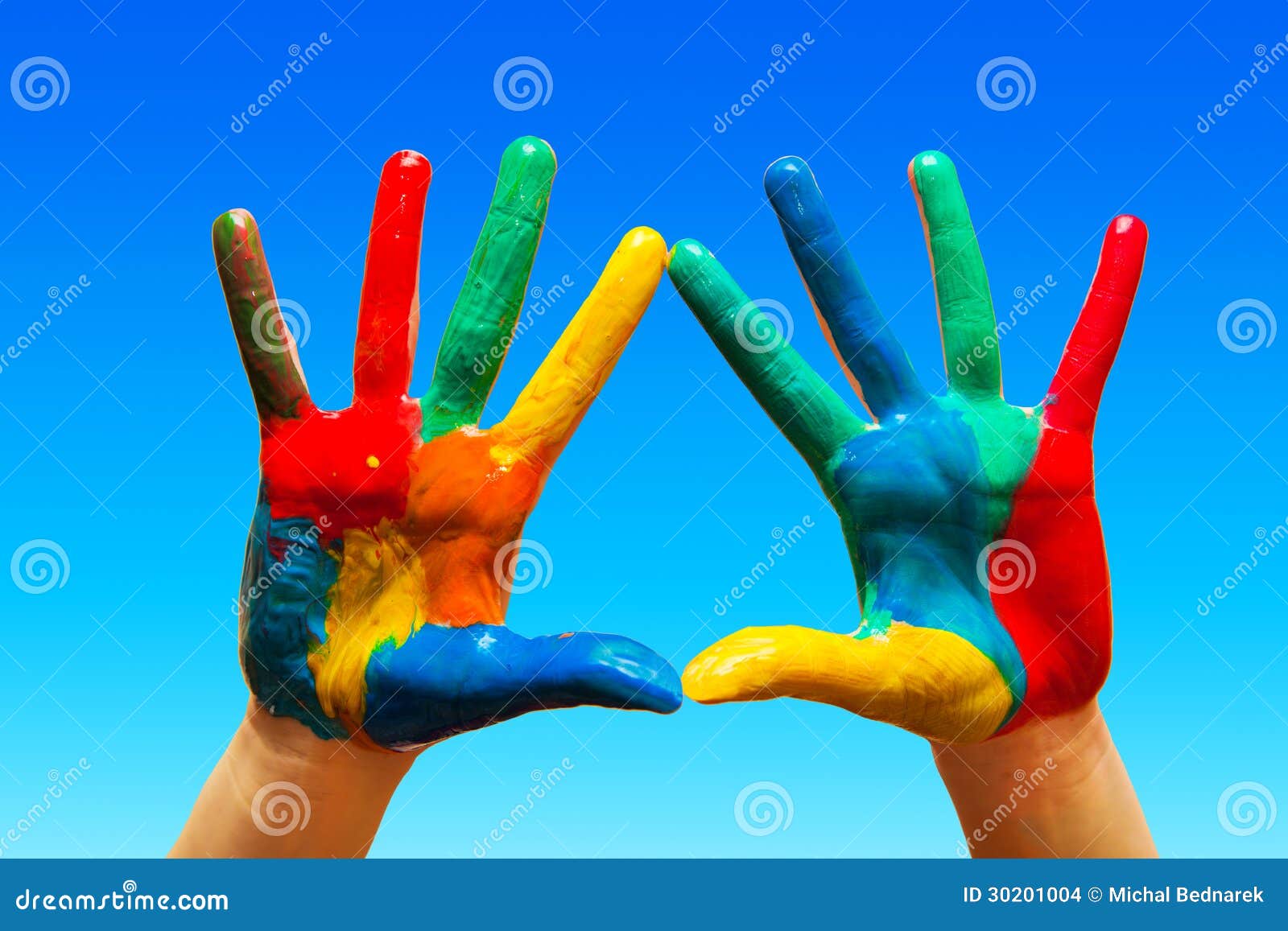 painted hands, colorful fun. blue sky