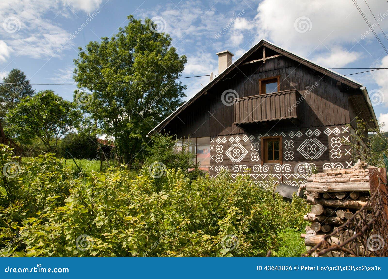 Painted Wooden House with wooden fence. The view on traditional painted houses in Cicmany village - Slovak Republic.