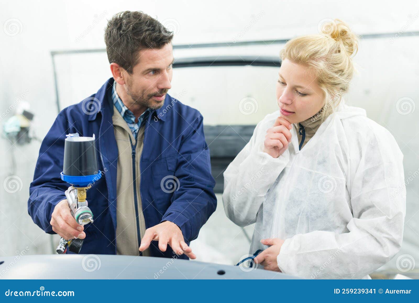 Painter with Airgun Explaining Technique To Spray Car Stock Image