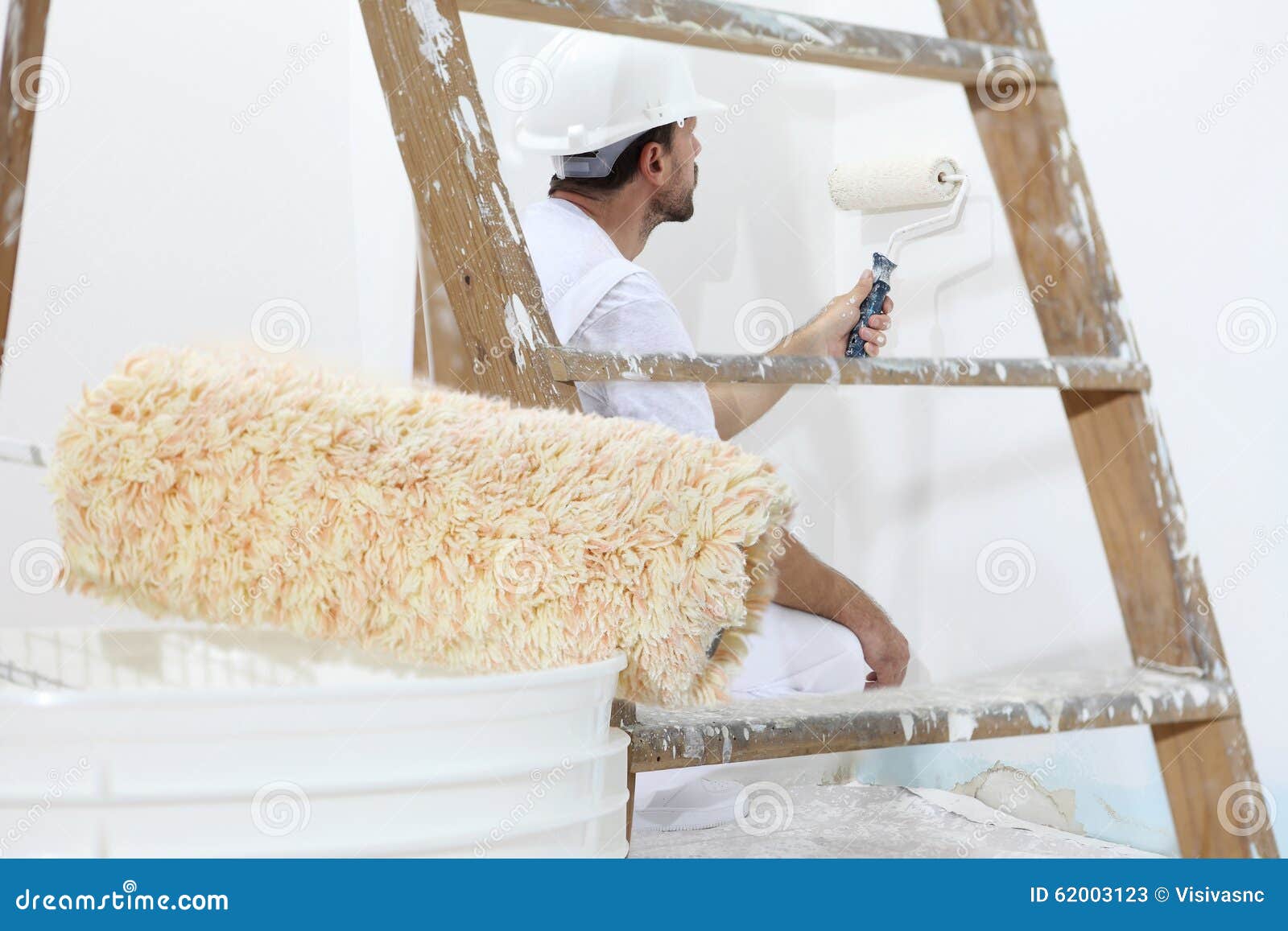 Painter Man at Work with Paint Roller, Wall Painting Concept Stock