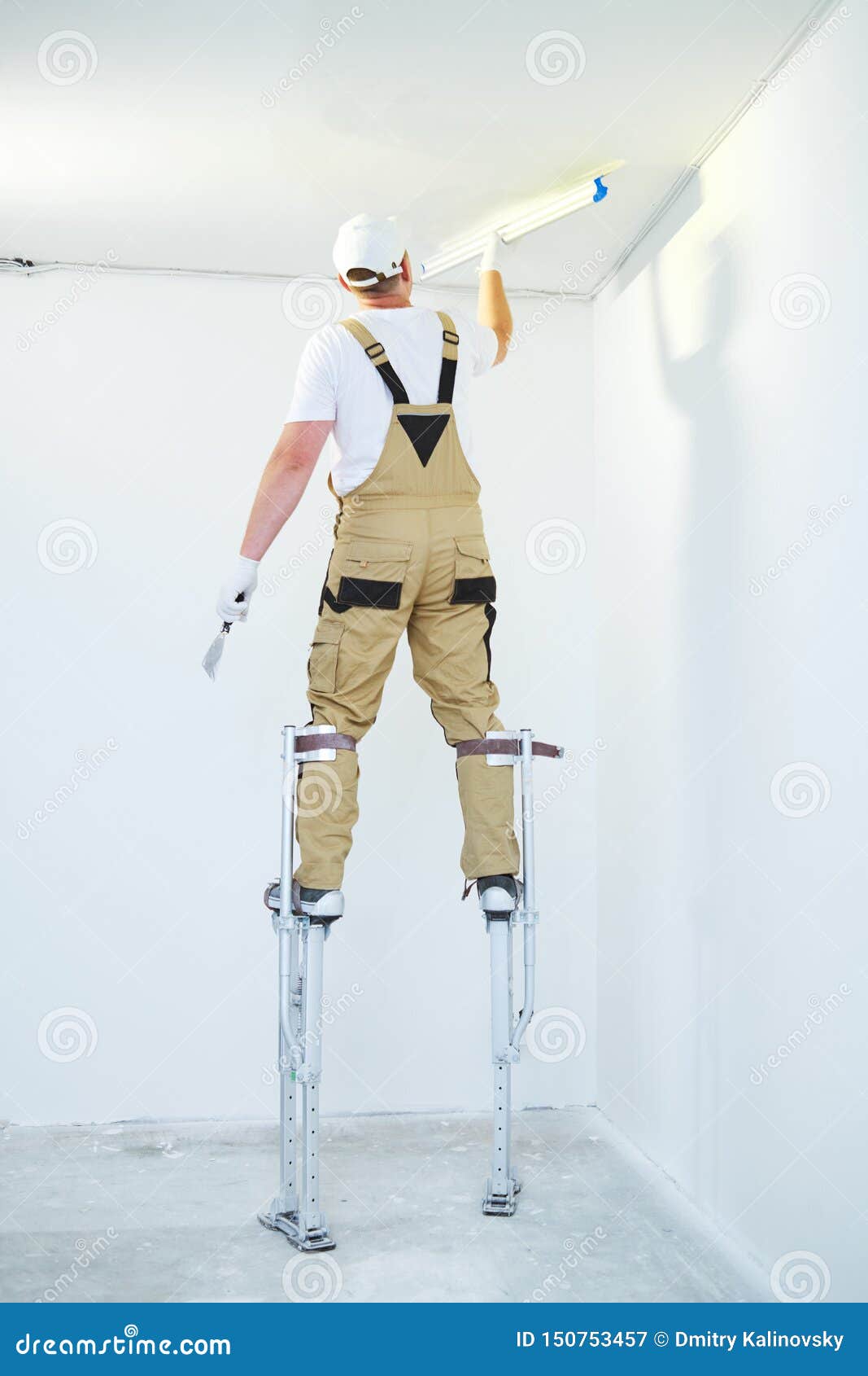 Painter In Stilts With Putty Knife Plasterer Smoothing Ceiling