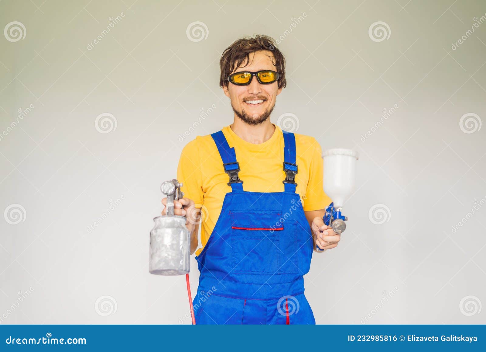 Painter in Work Clothes with a Paint Spray Gun Stock Photo Image of