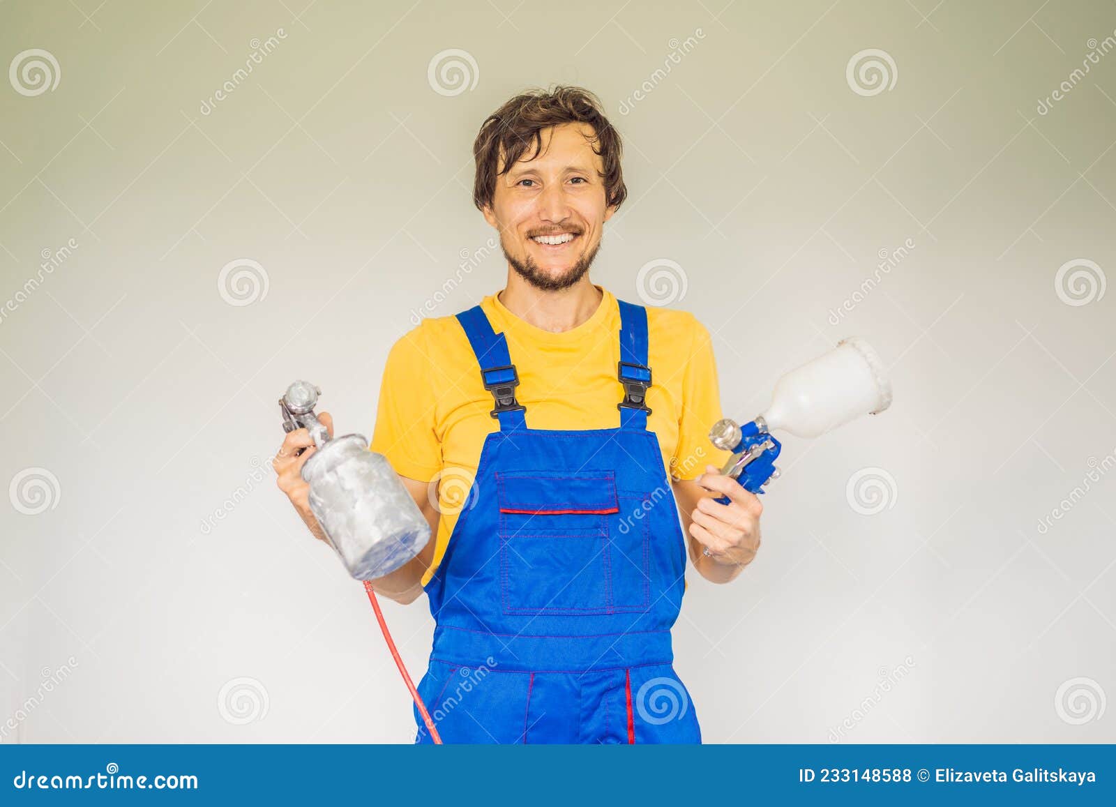 Painter in Work Clothes with a Paint Spray Gun Stock Photo Image of
