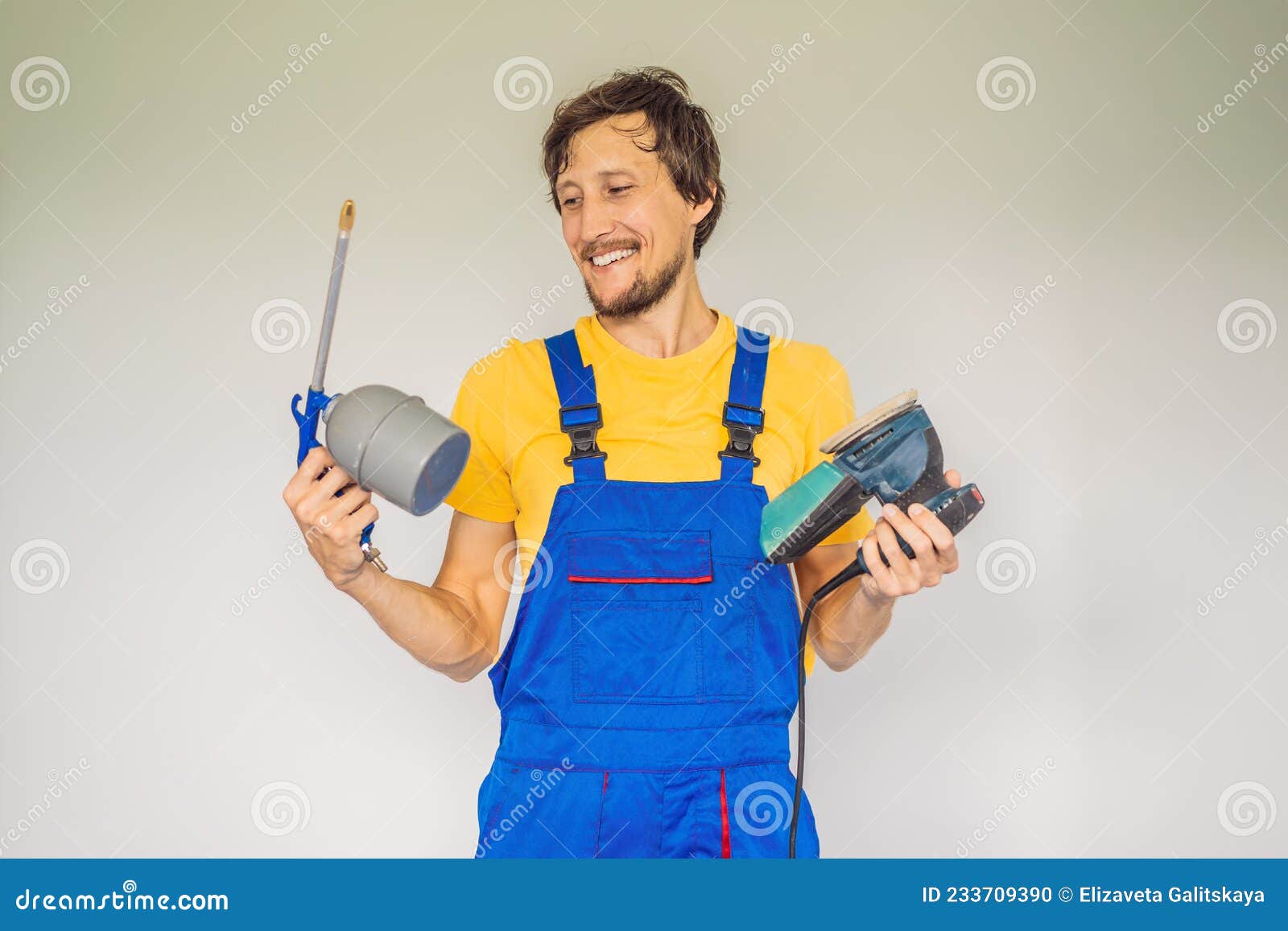 Painter in Work Clothes with a Paint Spray Gun Stock Photo Image of