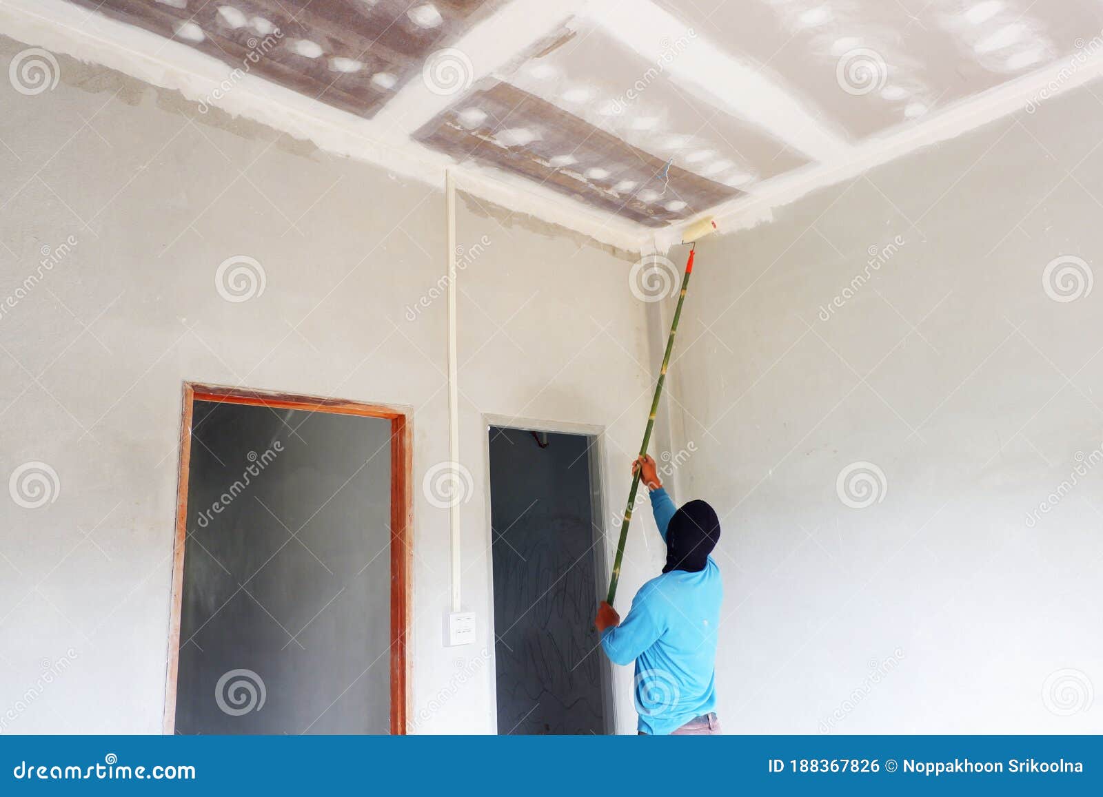 painters are painting the ceiling of a new home