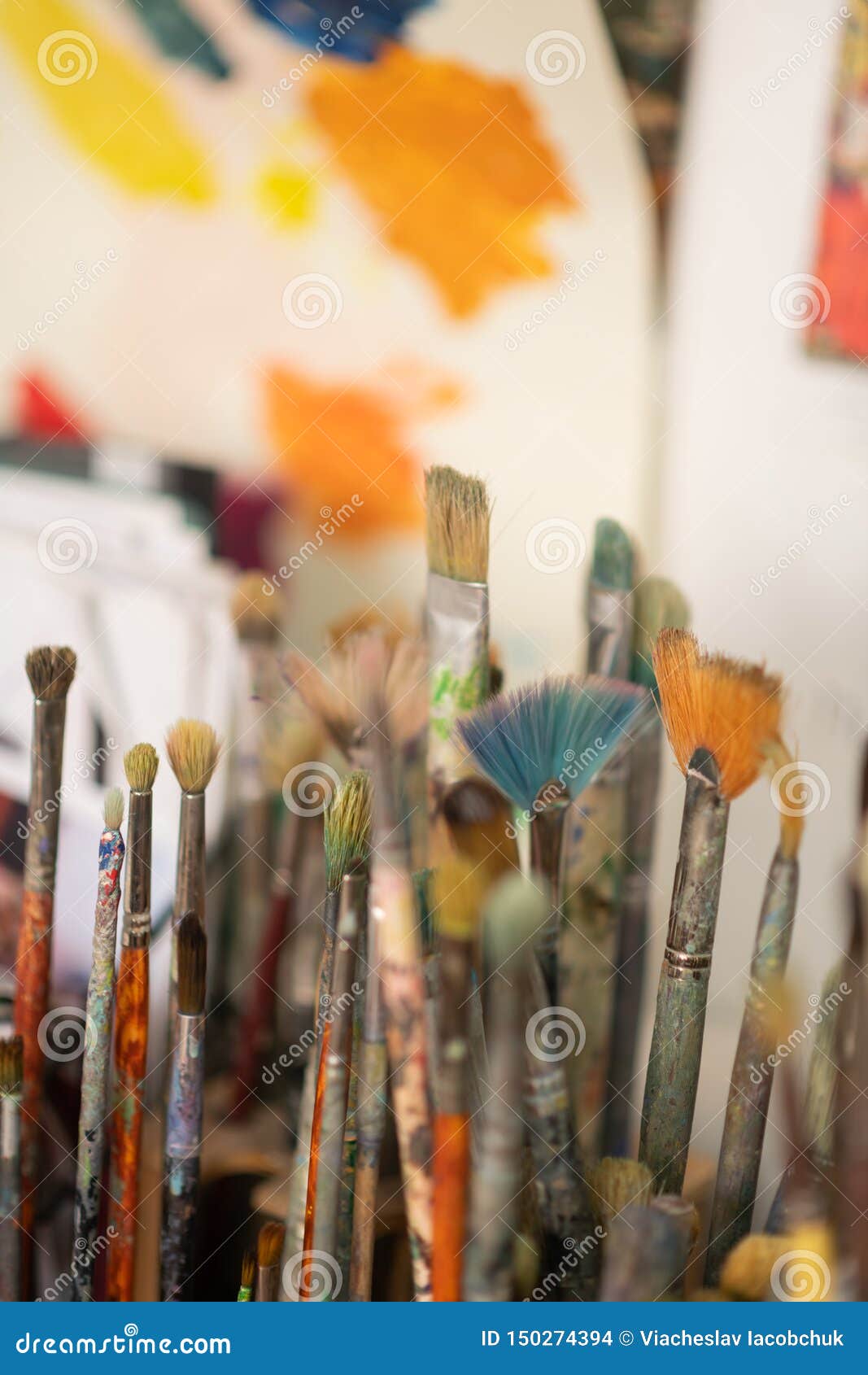 Painting Brushes Standing Near the Wall in Artistic Stock