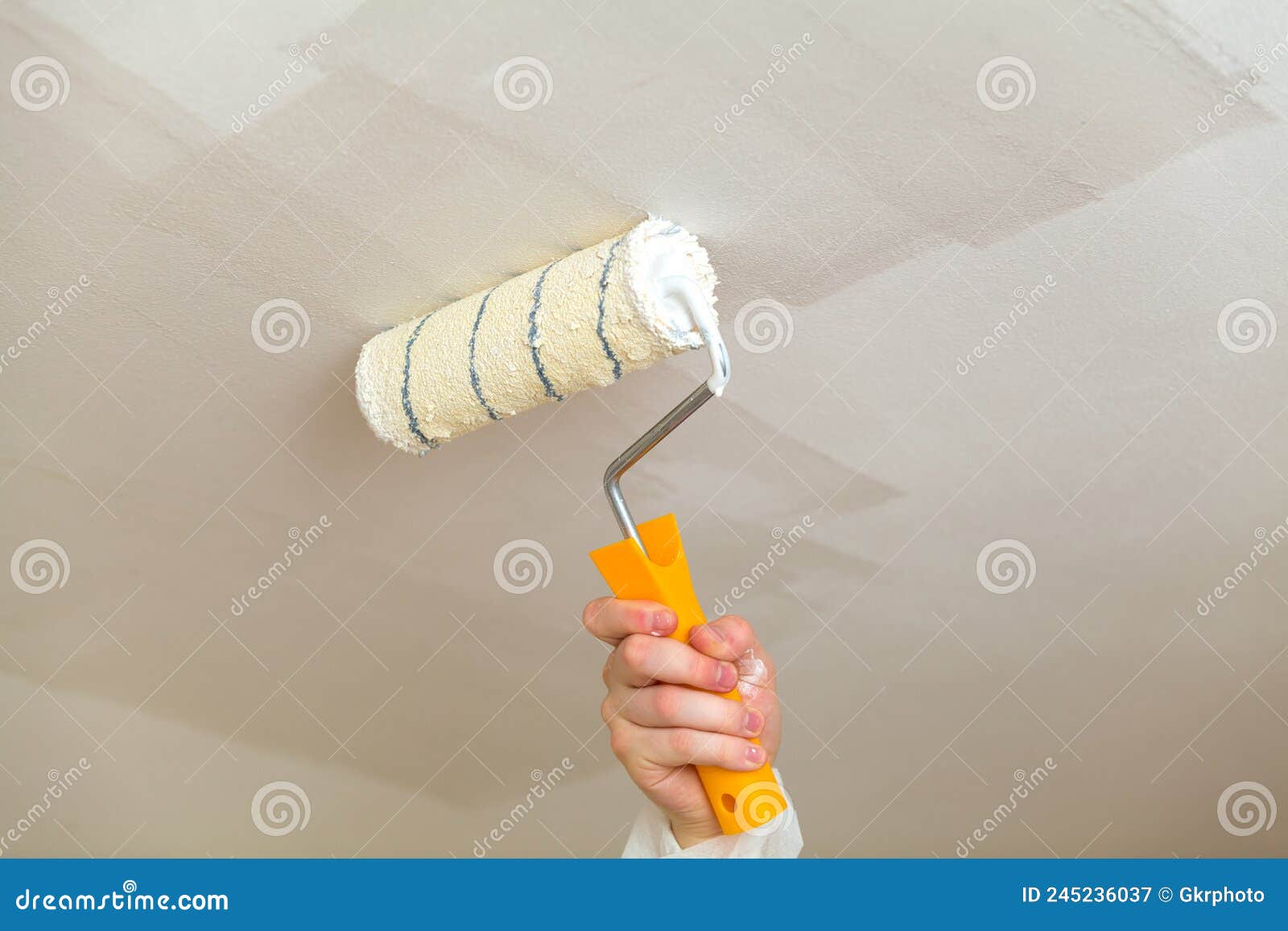 Painting the Ceiling a Roller with White Paint Stock Image Image of