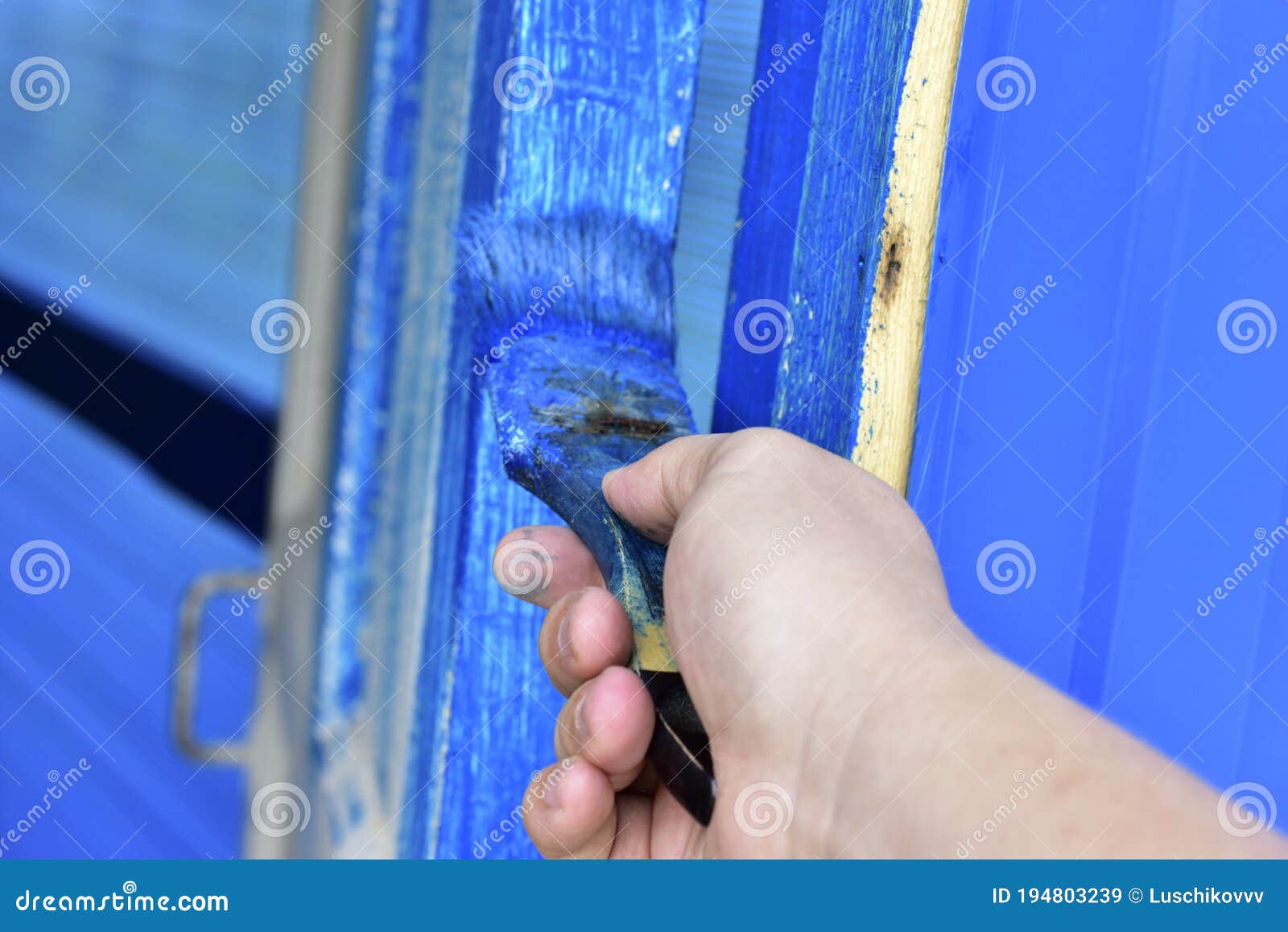 Painting the Door with Blue Paint Brush in Hand Stock Image Image of