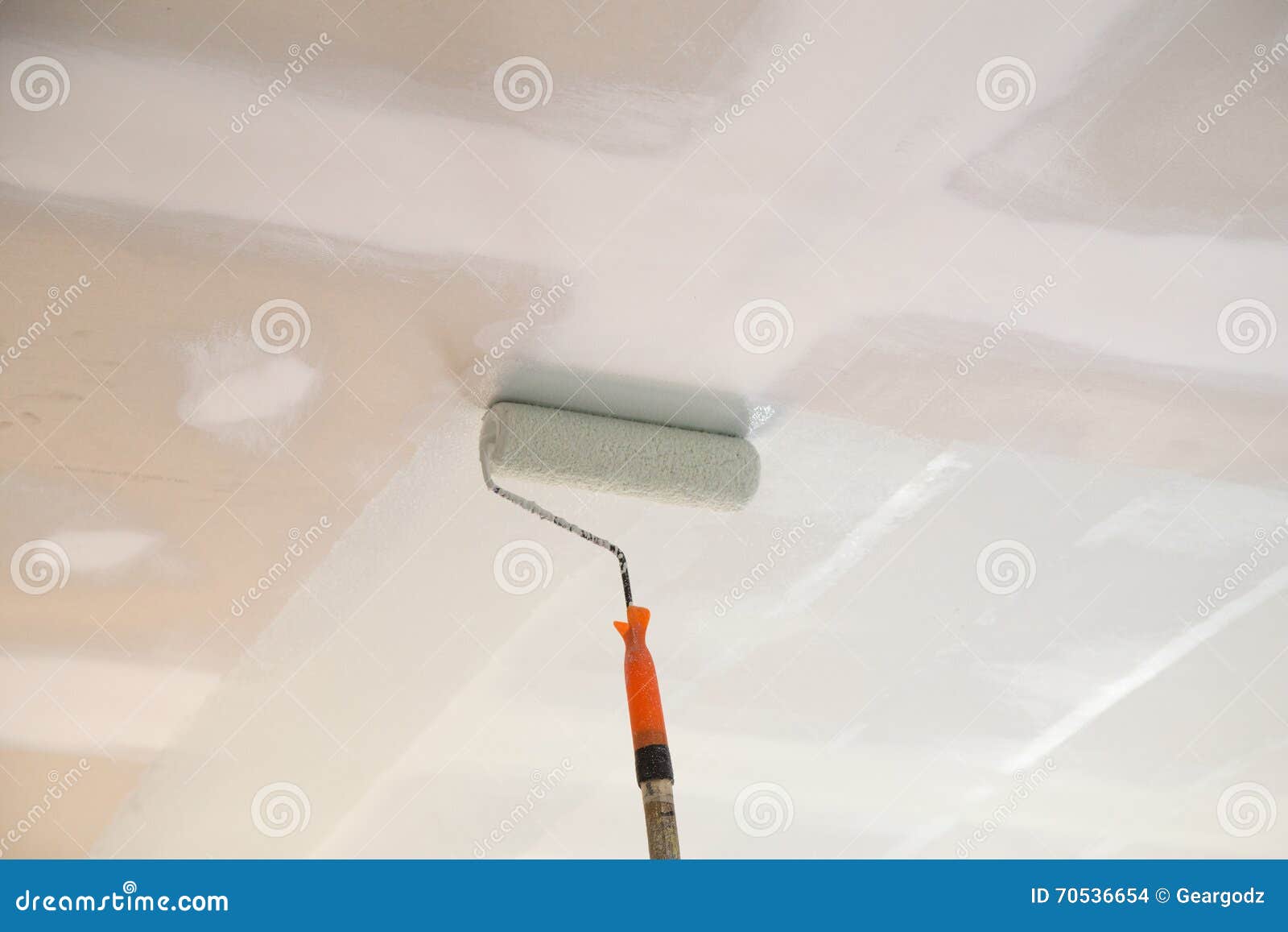 Painting A Gypsum Plaster Ceiling With Roller Stock Photo