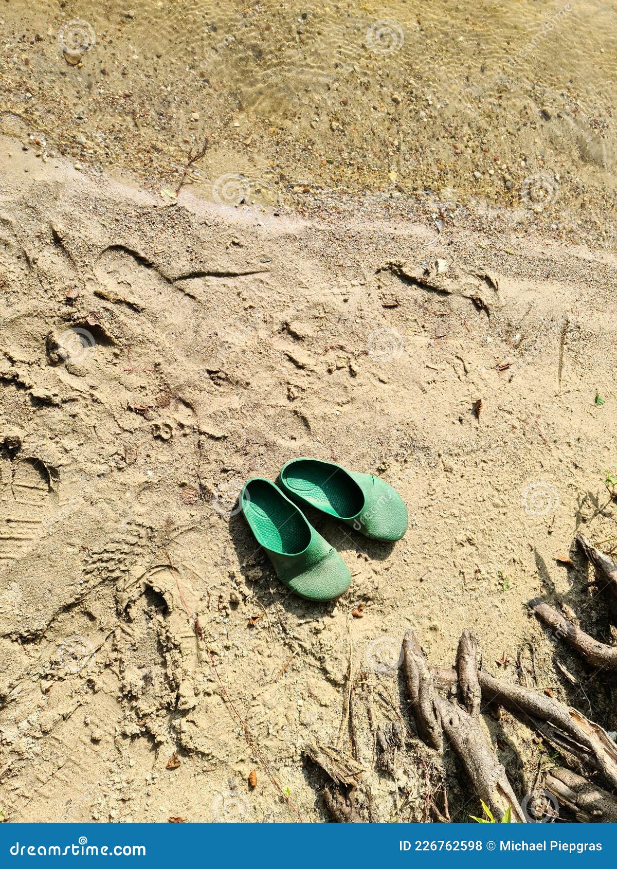 A Pair of Abandoned Flip Flops in the Sand at a Lake Stock Photo ...