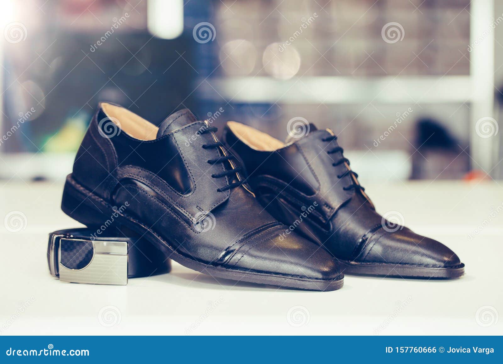 Pair of Black Elegant Leather Shoes and Belt on a Shelf of a Shop Stock ...