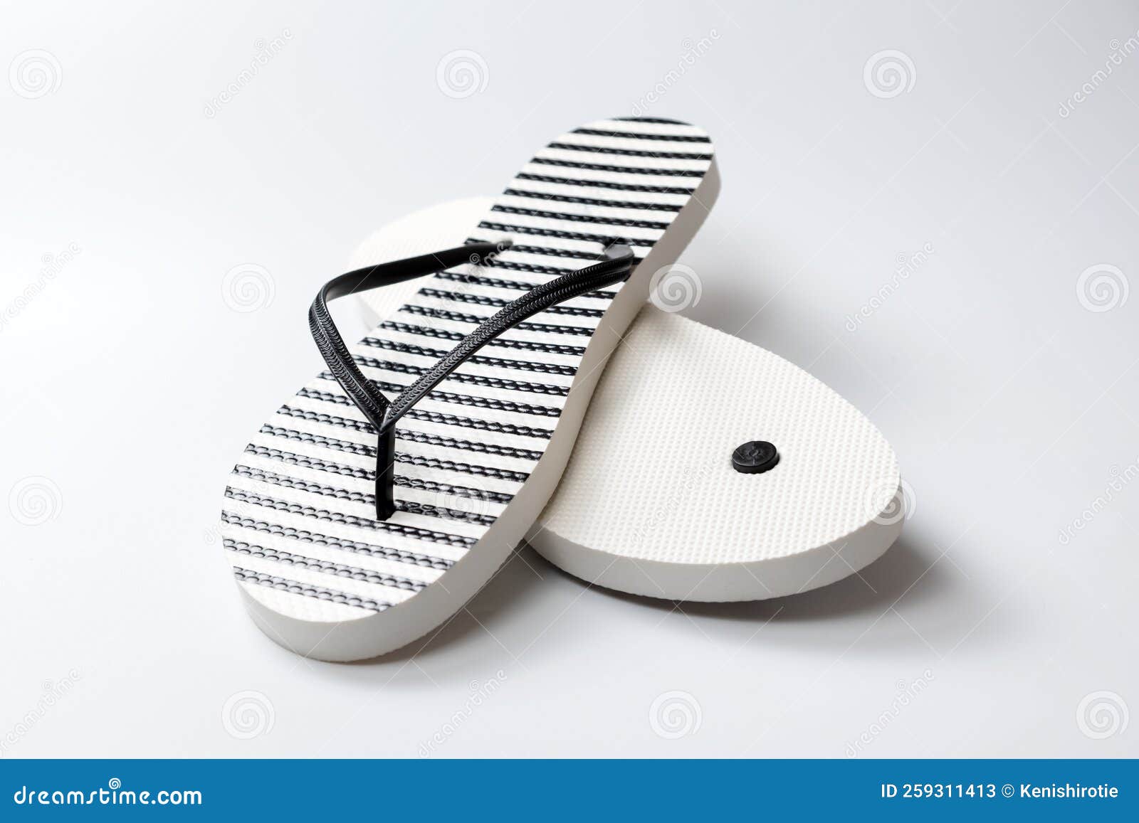 Pair of Black and White Stripe Flip Flops Isolated on White Background