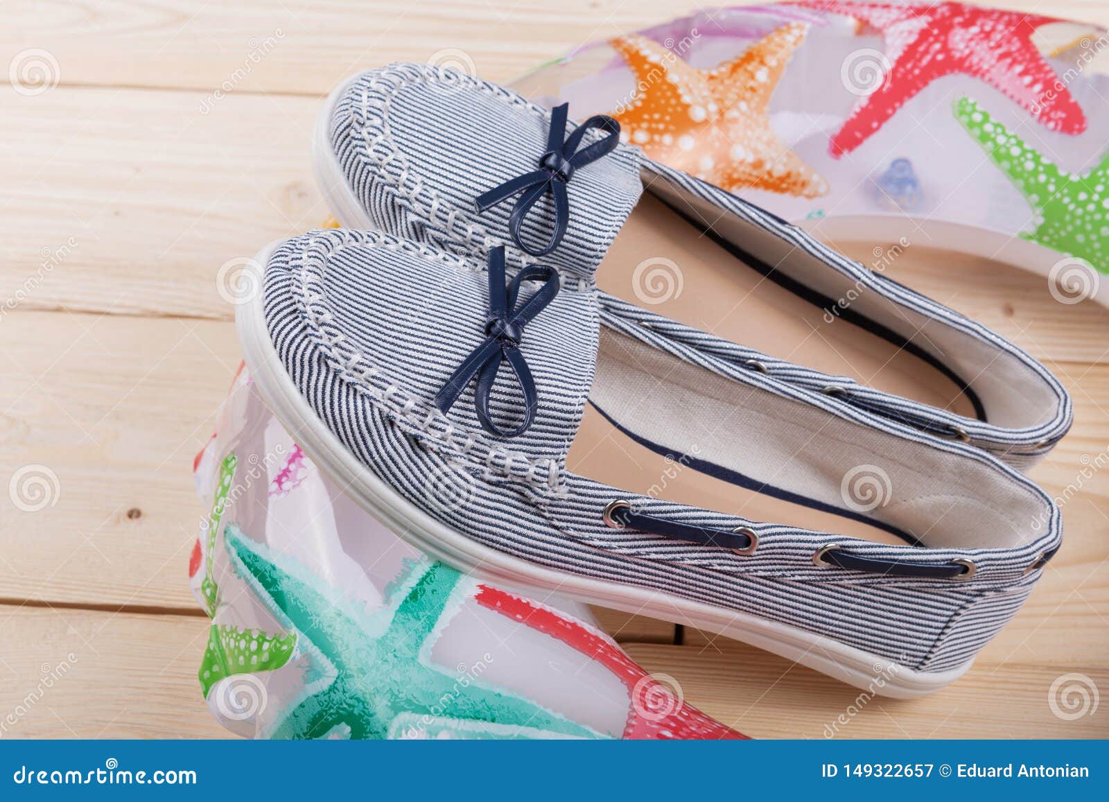 Pair of Blue Summer Shoes and an Inflatable Circle on Wooden Boards ...