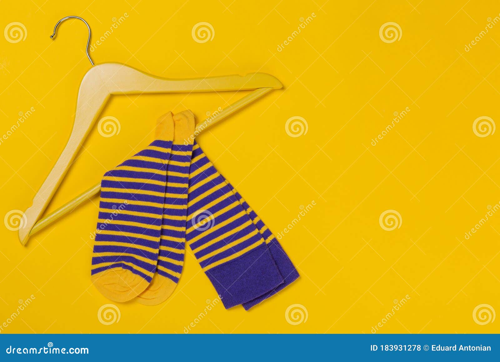 Pair of Blue Yellow Striped Socks on a Yellow Wooden Hanger, Shopping ...
