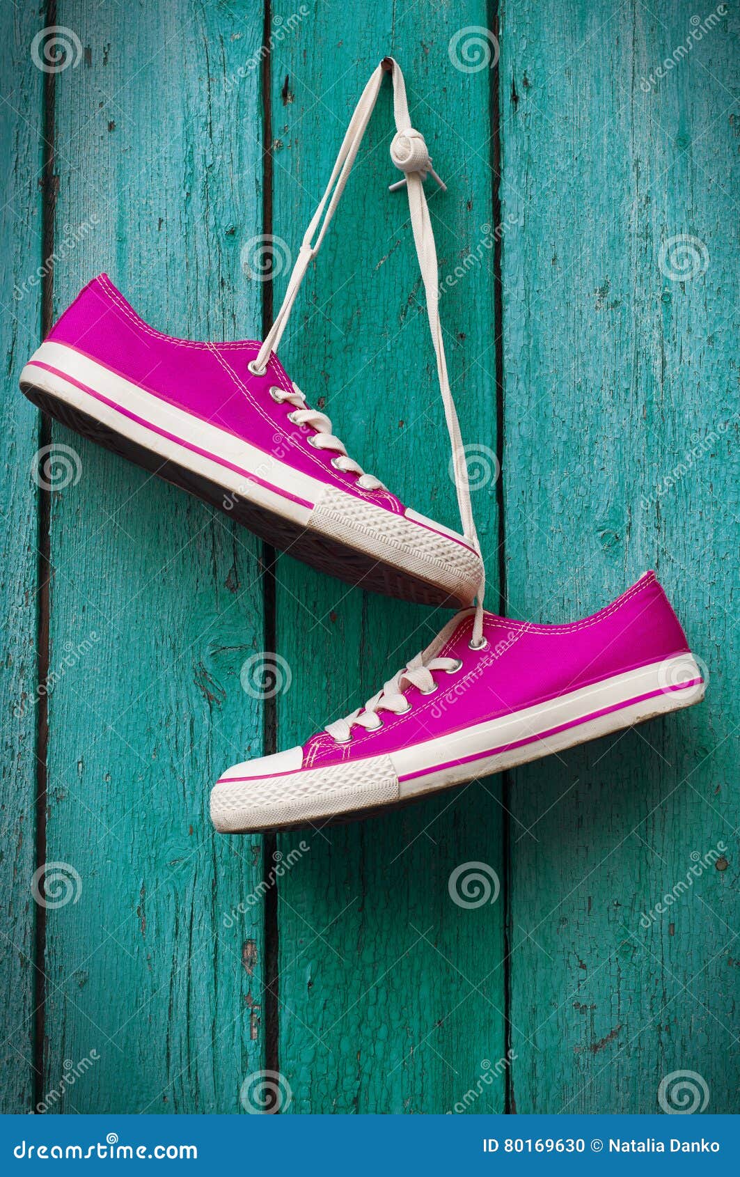 Pair of Bright Pink Sneakers Hanging on a Cord Stock Photo - Image of ...