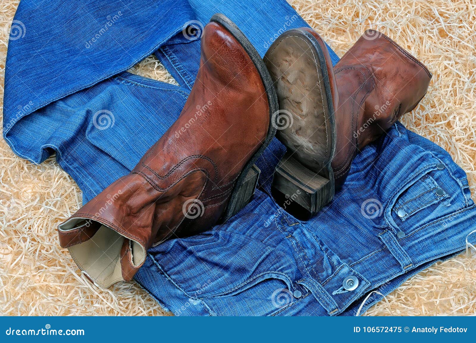 Pair of Cowboy Boots and Blue Jeans on Straw Stock Image - Image of ...