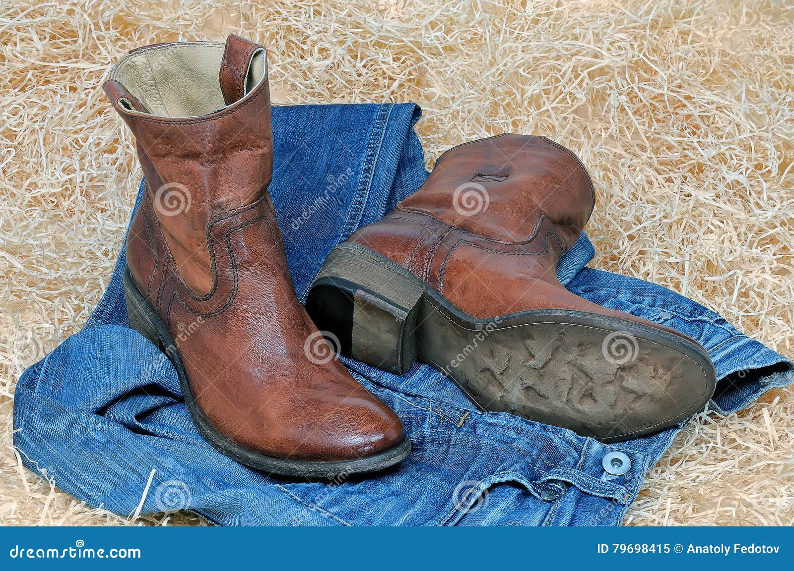 Pair of Cowboy Boots and Blue Jeans on Straw Stock Image - Image of ...