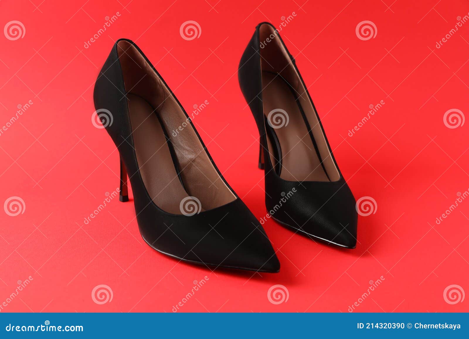 Pair of Elegant Black High Heel Shoes on Red Background Stock Photo ...