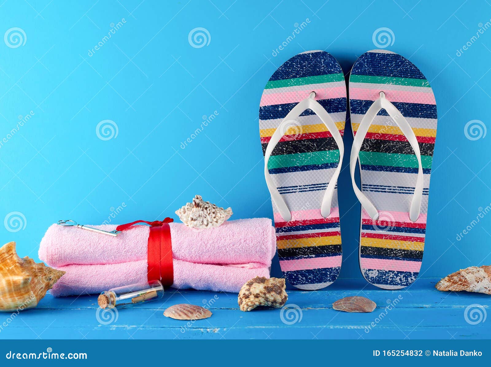 Pair of Female Beach Slippers and a Towels on a Blue Background Stock ...