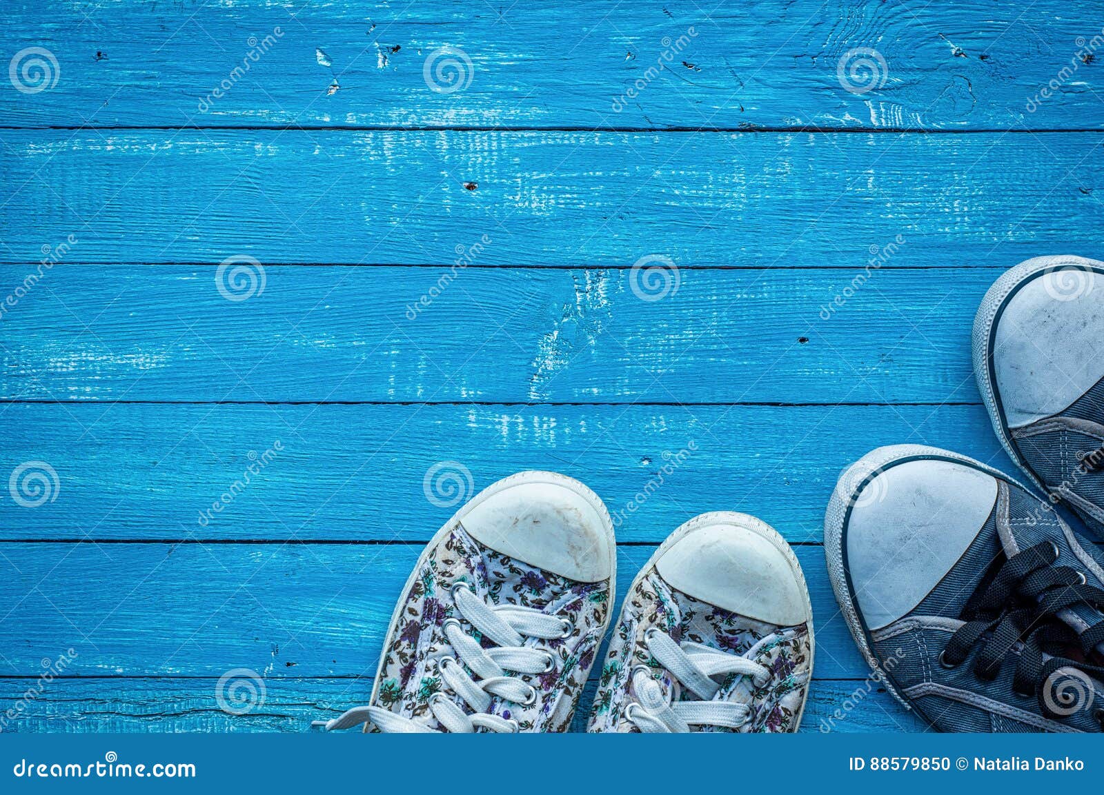 Pair of Female and Male Worn Sneakers on a Wooden Board Stock Photo ...