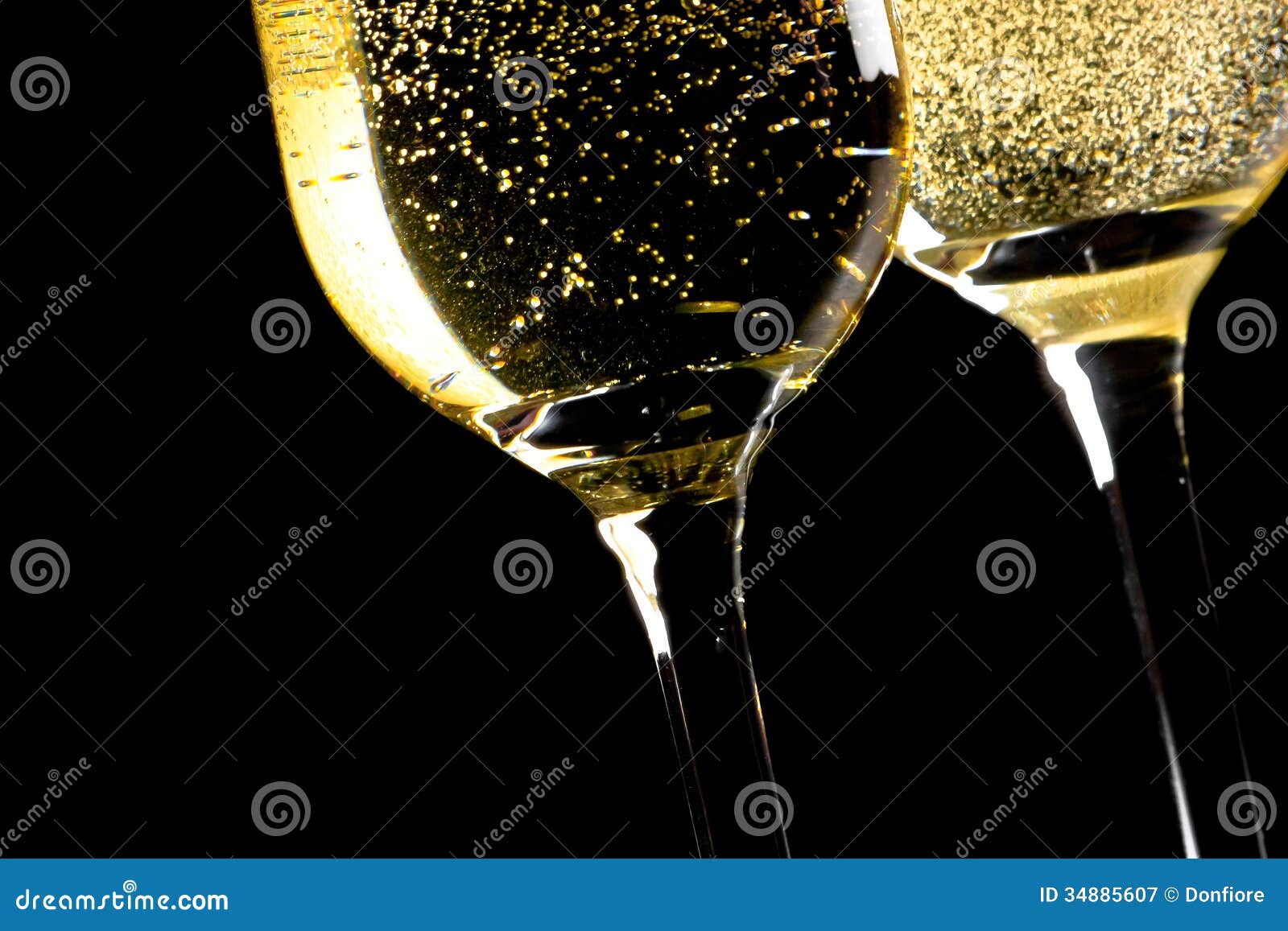 A Pair of Flutes of Champagne Tilted with Golden Bubbles Stock Image