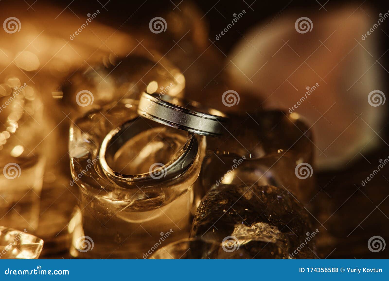 Pair Gold Wedding Rings Ice Cubes Sparkle Reflection Stock Photo