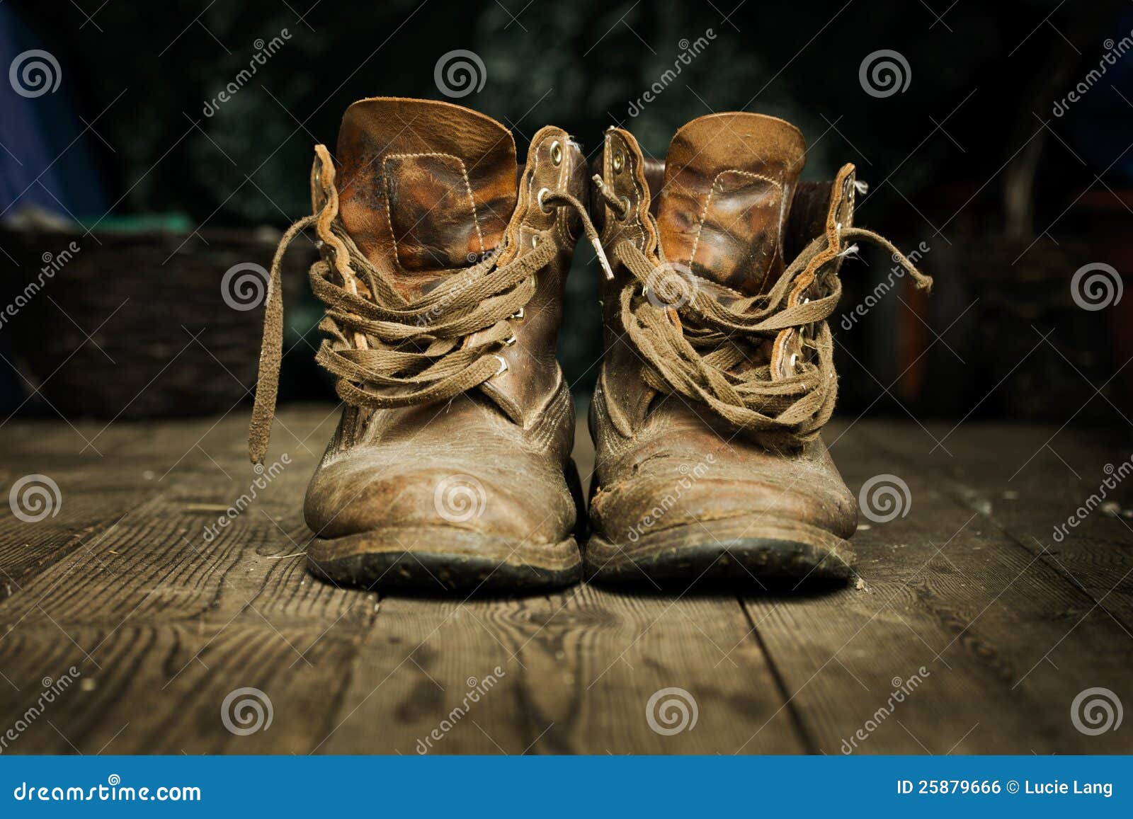 pair of old boots on wooden floor boards