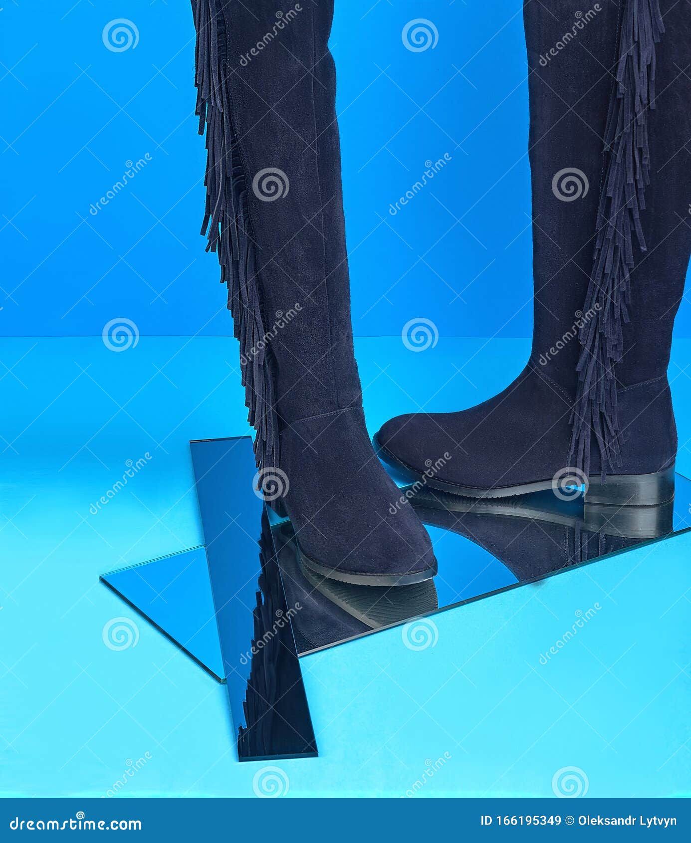 Pair of Purple Suede Women`s Fringed Boots on a Blue Background with ...