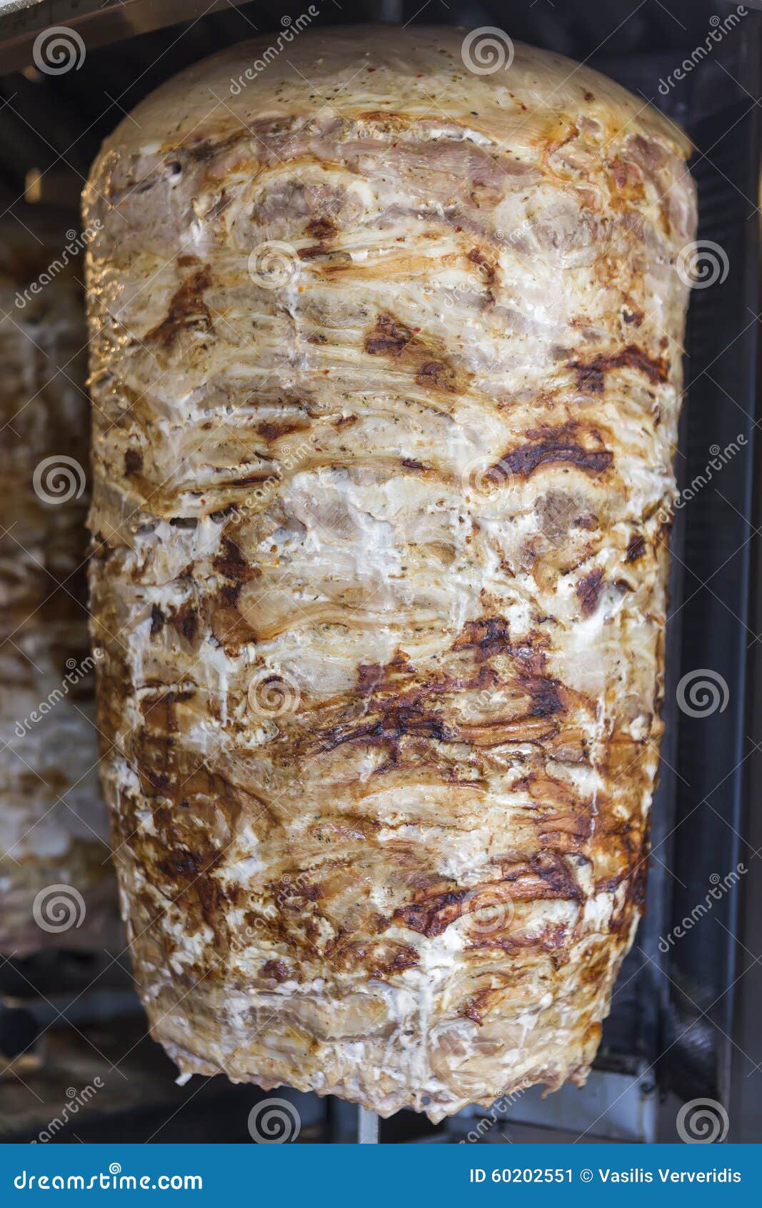 a pair of rotating skewered chicken and lamb meat grilled and re