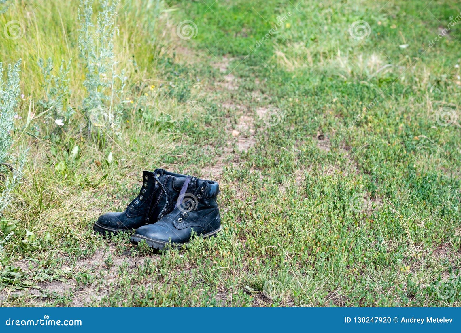 A Pair of Shoes Left by a Man on the Road in a Field Stock Photo ...