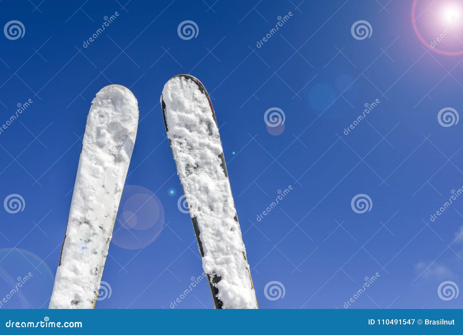 Pair of Skis Against Blue Sky, Sun Flares Stock Image - Image of bokeh ...