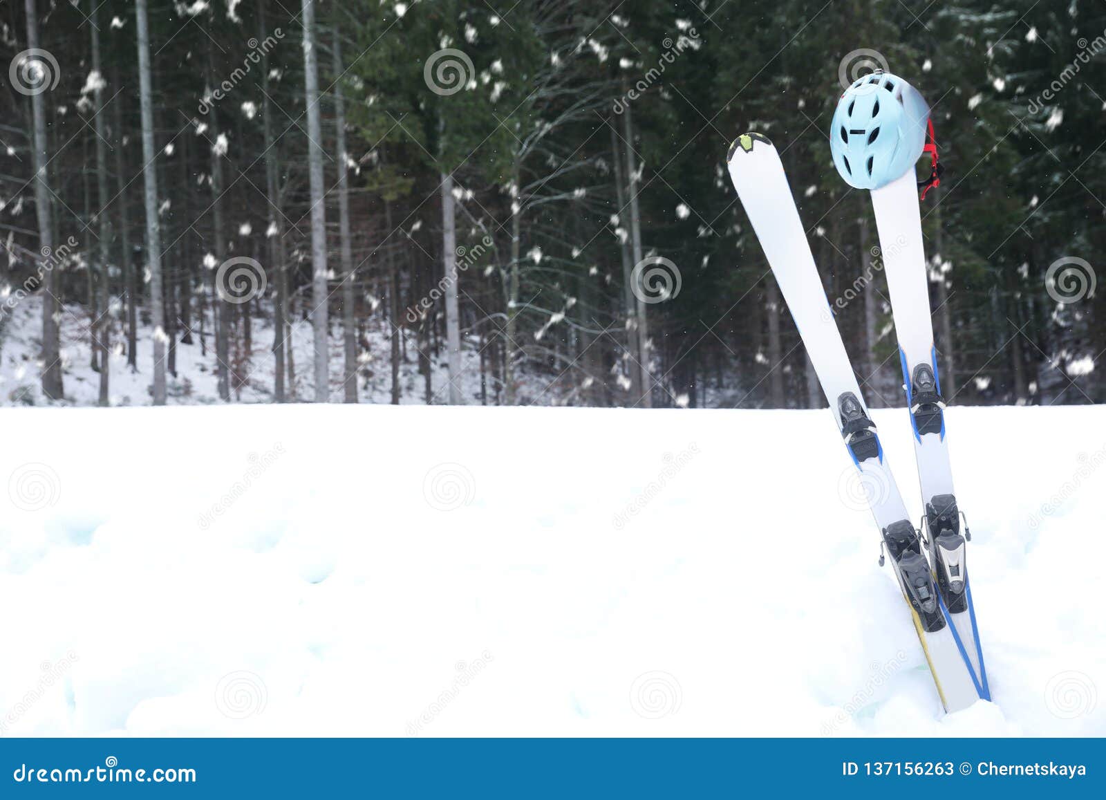 Pair of Skis with Helmet in Snow Near Forest, Space for Text Stock ...