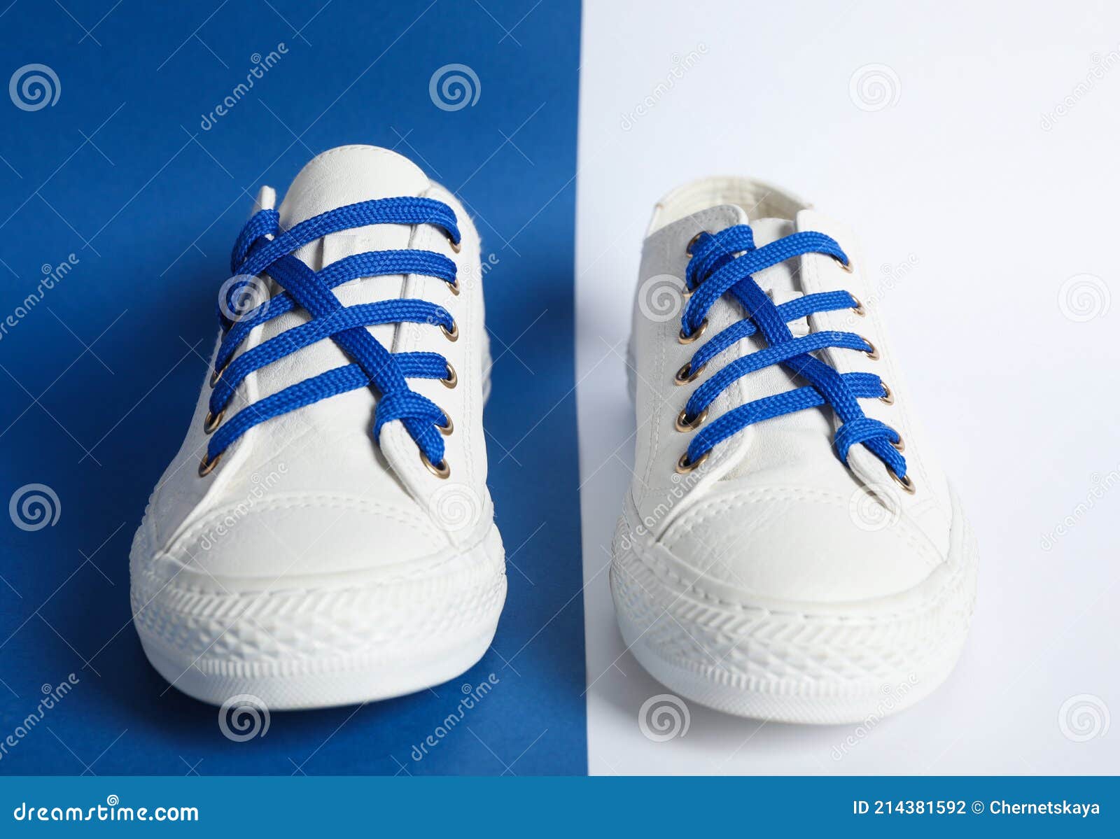 Pair of Stylish Shoes with Blue Laces on Color Background Stock Photo ...