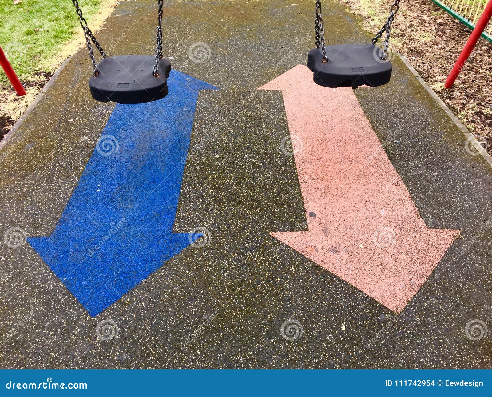 A Pair Of Swings And Arrows In A Kids Playground Stock Photo