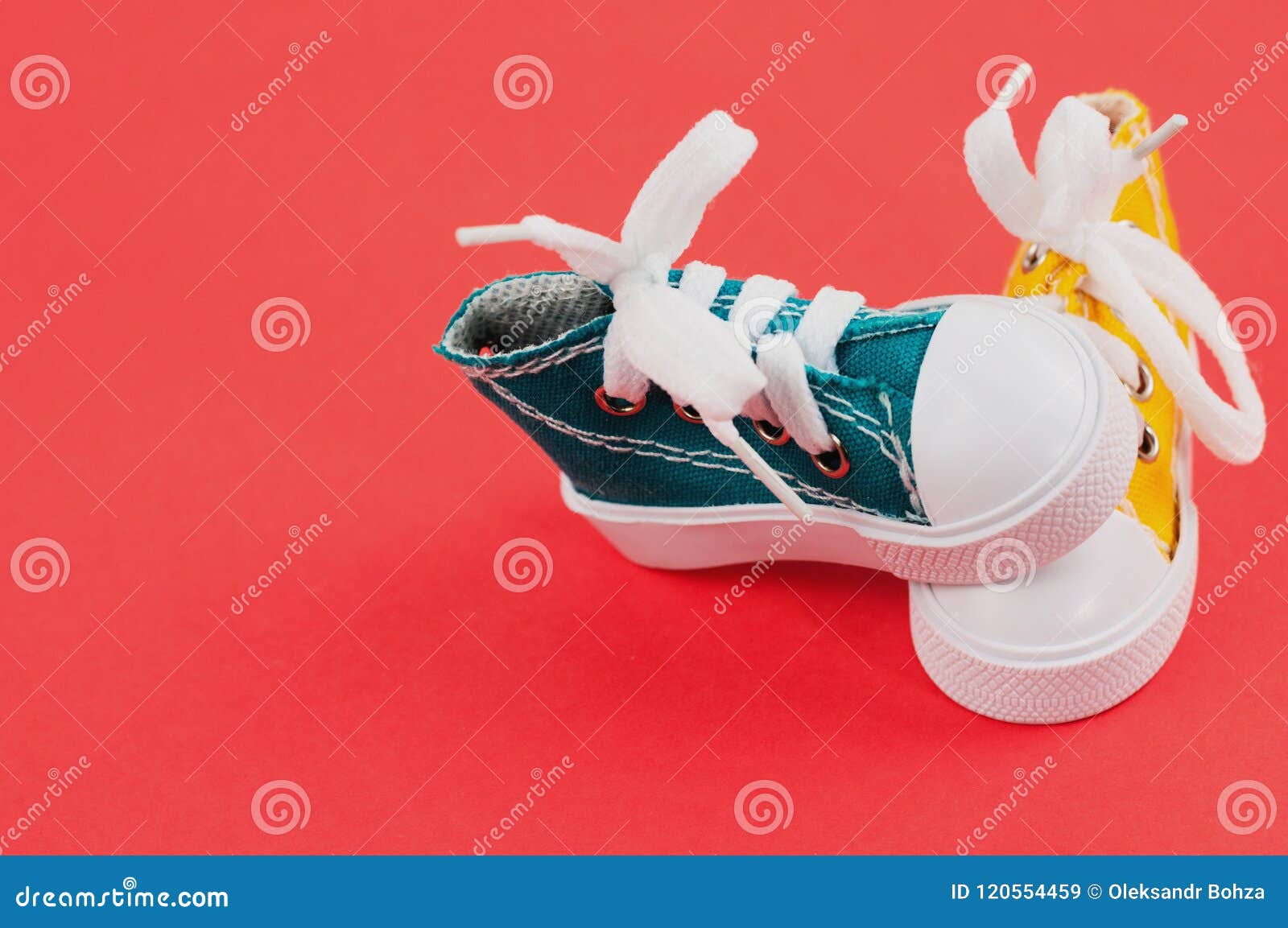 Pair of Yellow and Green Color Gym Shoes on Red Paper Stock Image ...